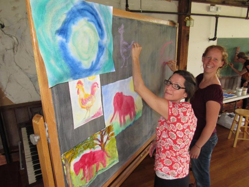 High school teachers Amy Kortus (left) and Emily Turner (right) practice their cartooning skills while taking a break from their Waldorf high school teacher training.